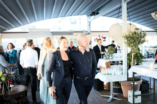 Couple walking together at an event with guests