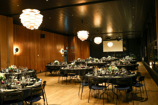 Elegant event space set with round tables for dining