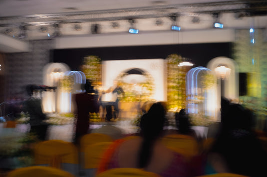 Blurred stage with performers and audience at an event
